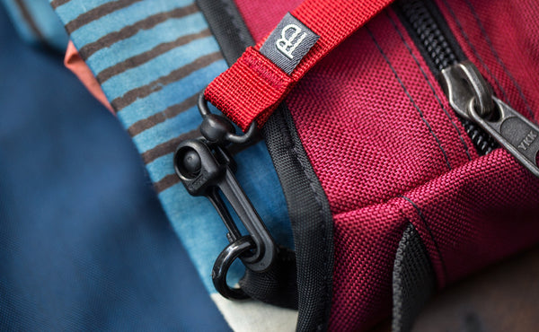 A close shot of a the snaphook of a Key Strap attached to the o-ring in a Small Cafe Bag.